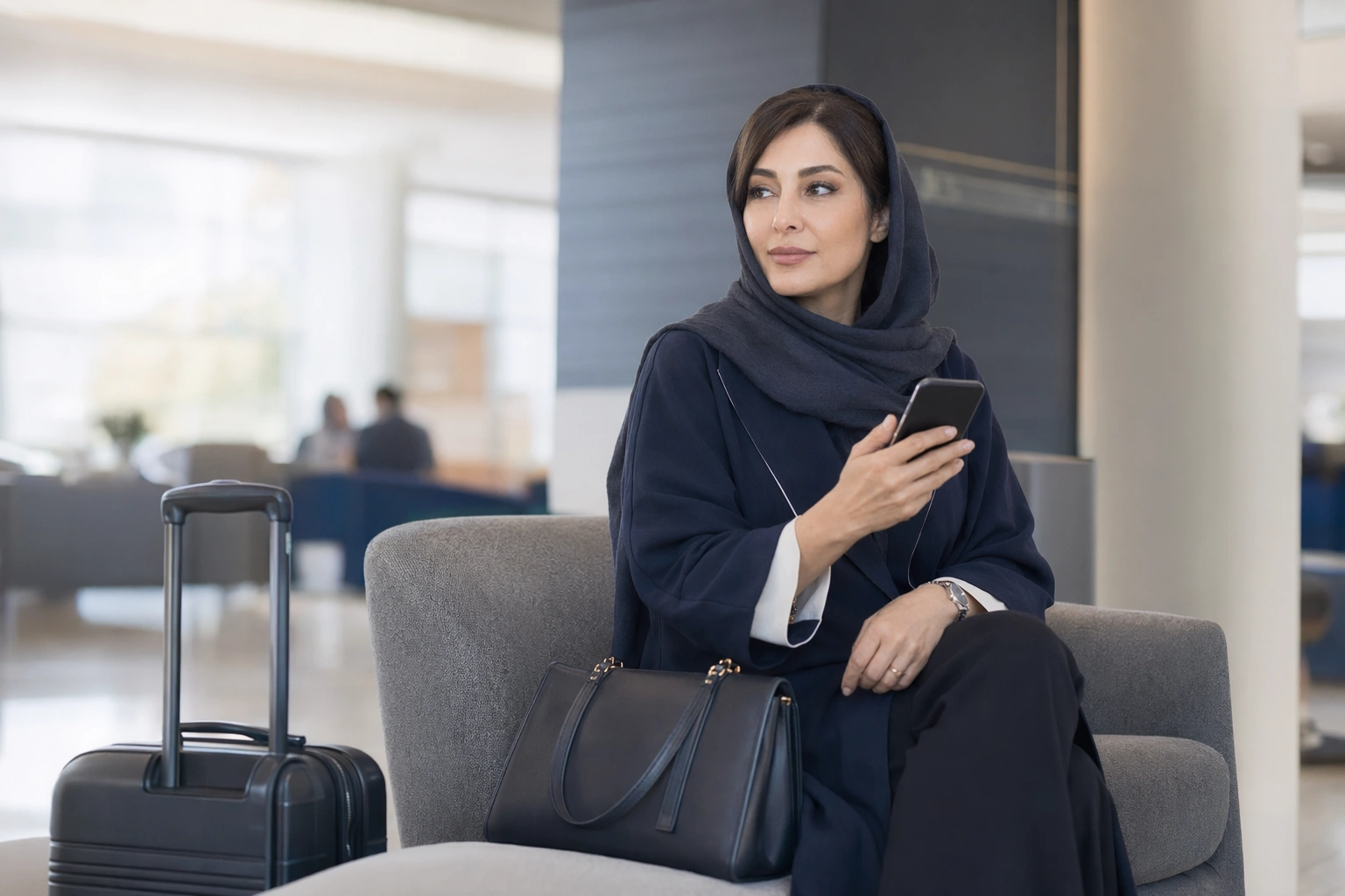 کوچ ایرانی در سفر کاری در لابی هتل با موبایل و کیف دستی، در حال مدیریت حرفه‌ای رزرو جلسات
